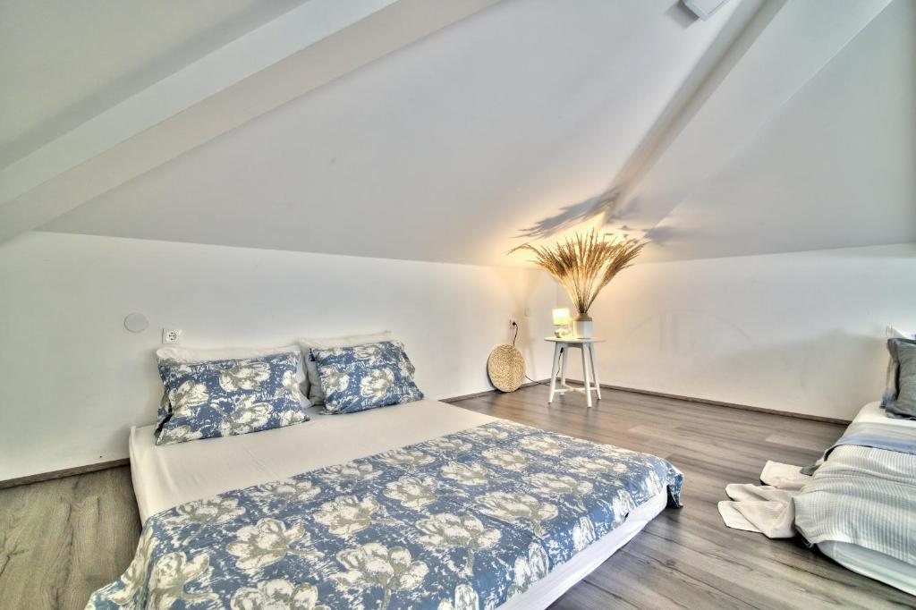 a bedroom with a bed and pillows on a wooden floor at Dida moj in Senj