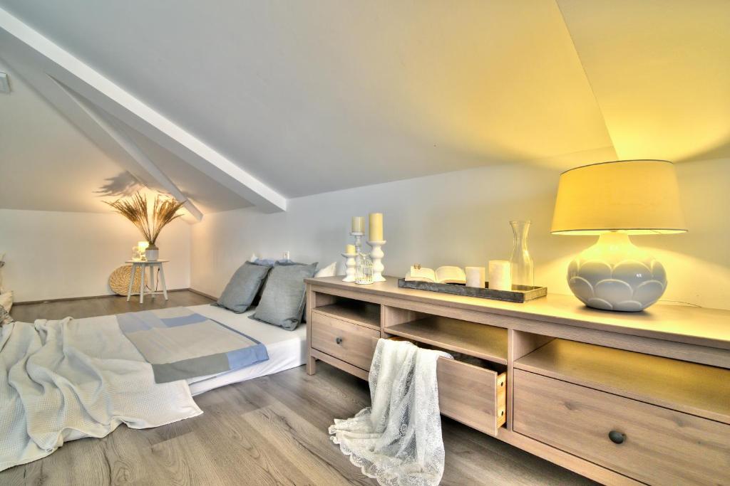a bedroom with a bed and a table with a lamp at Dida moj in Senj