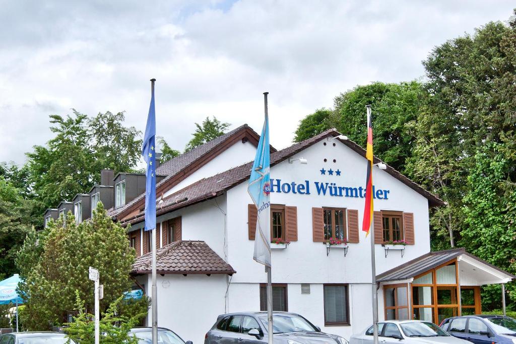 a building with flags in front of it at Würmtaler Gästehaus in Munich