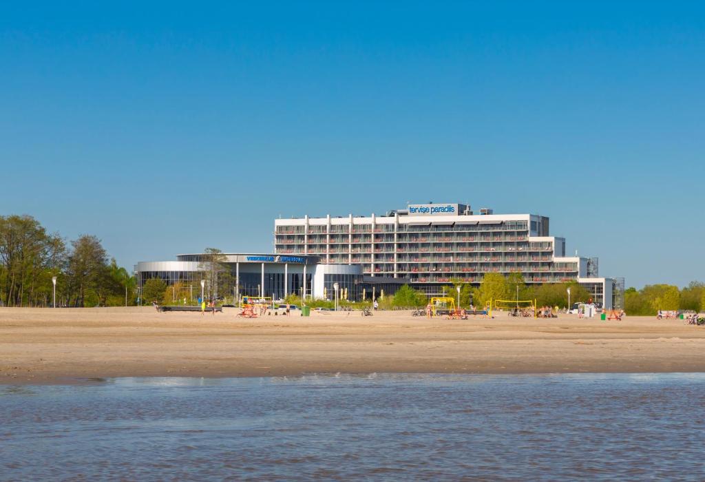 
a large white building with a blue sky at Spa Tervise Paradiis in Pärnu
