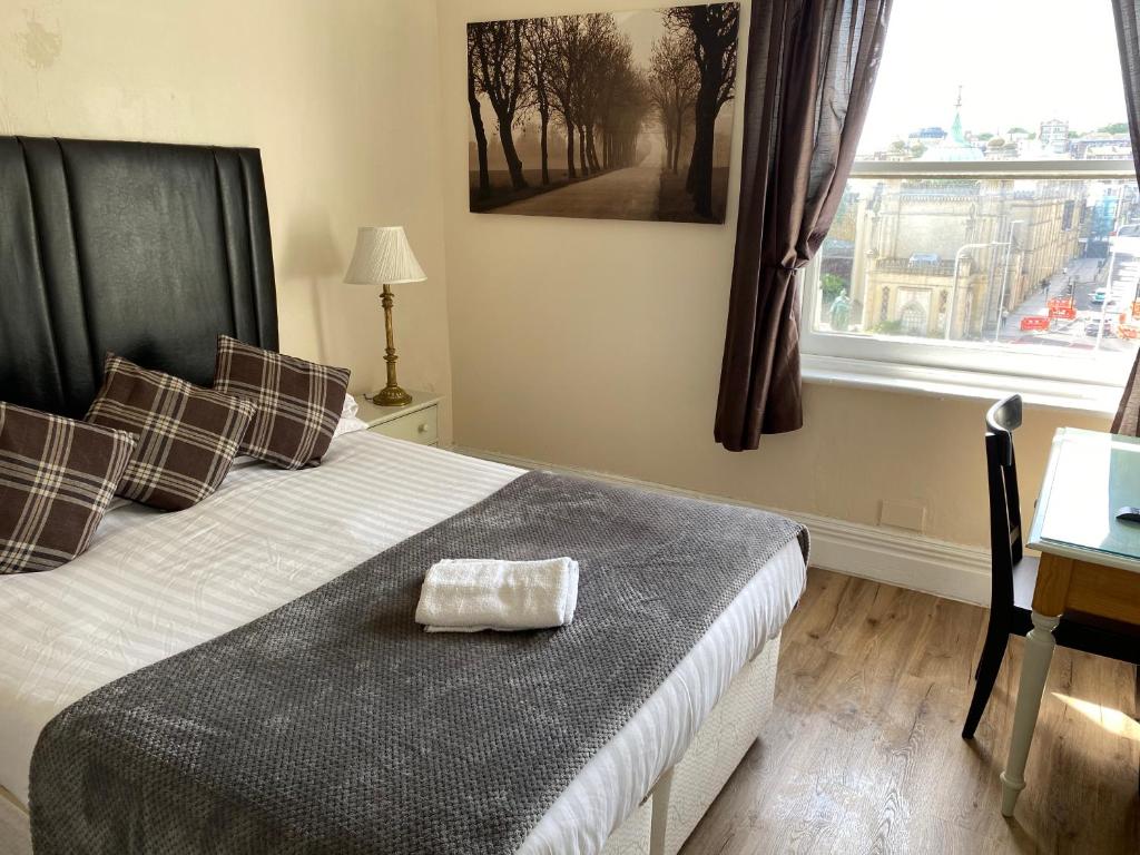 a bedroom with a bed with a bag on it at Kipps Brighton in Brighton & Hove