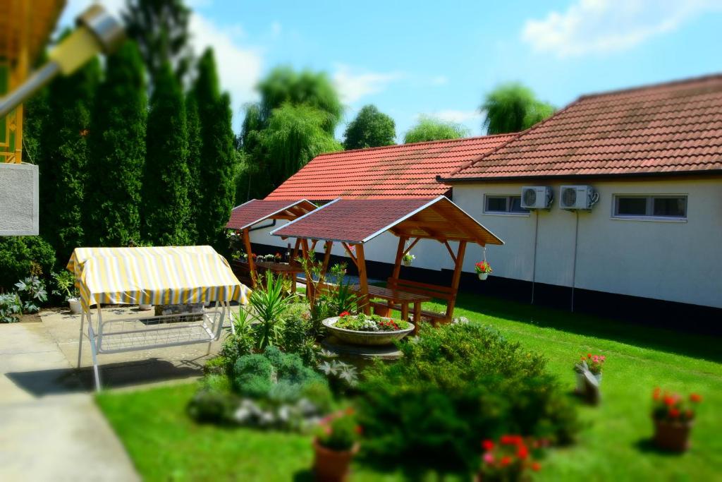 a house with a patio with a table and chairs at La Siesta Bogács Apartman in Bogács