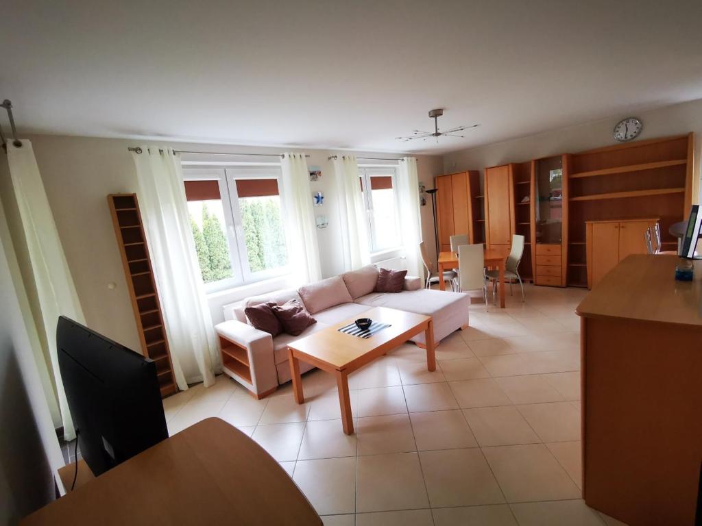 a living room with a couch and a table at Klimatyczny Kołobrzeg in Kołobrzeg