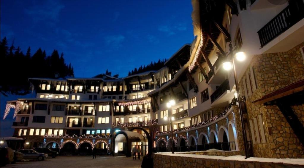 a large building at night with lights on at Private Apartment in Grand Monastery in Pamporovo