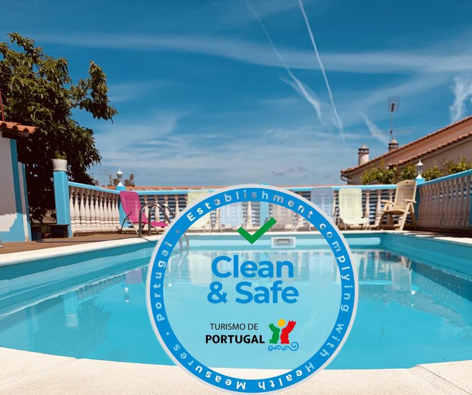a sign that reads clean and safe next to a swimming pool at Fatima Belavista & Pool in Fátima