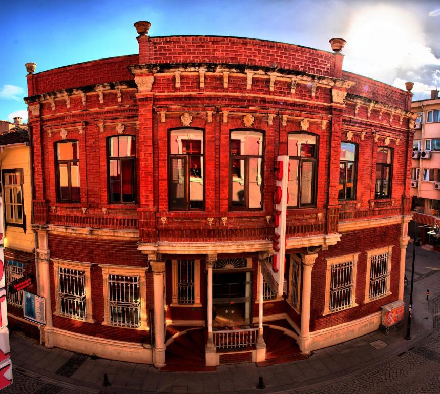 an old red brick building on a city street at Kervansaray Canakkale Hotel - Special Category in Canakkale