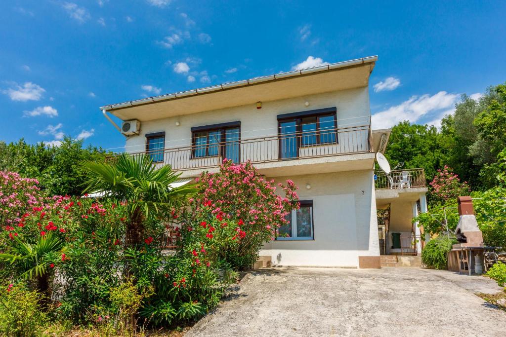 a house with flowers in front of it at Apartments Arijana in Dramalj