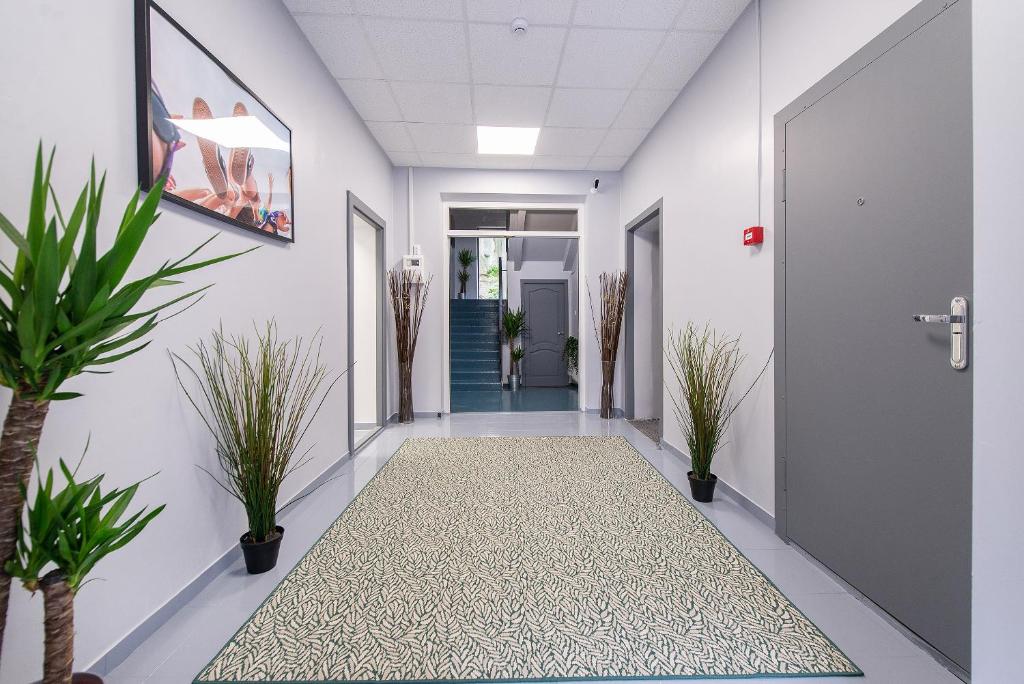 a hallway with potted plants and a door at The house Vilnius in Vilnius