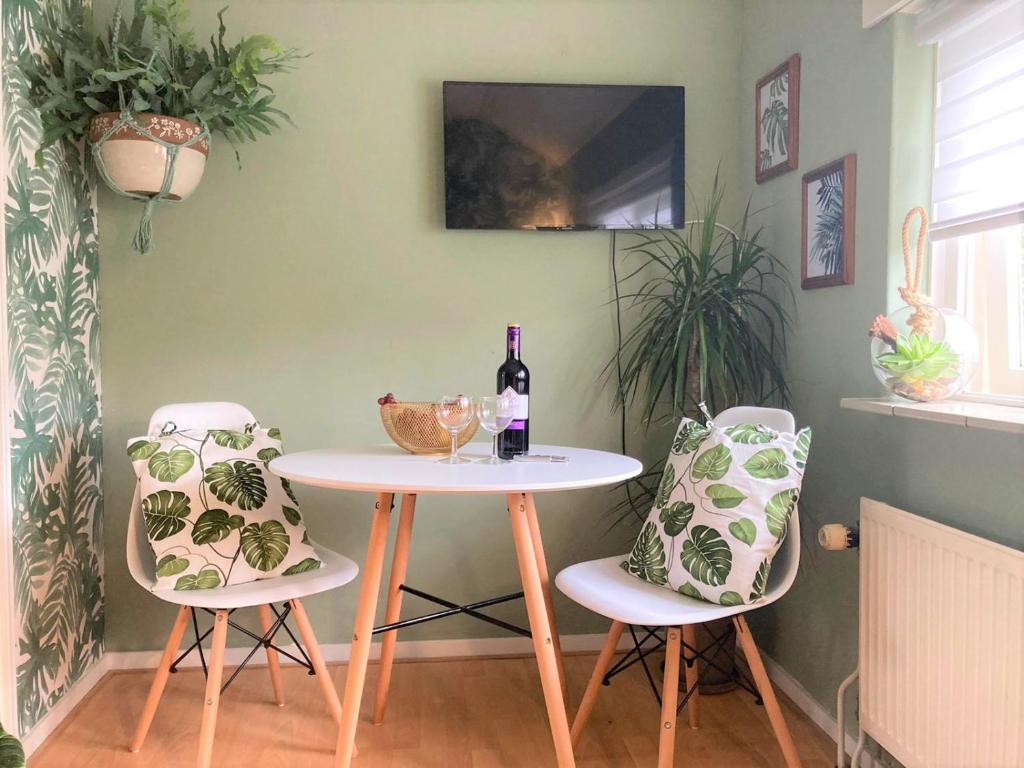 einen Tisch mit 2 Stühlen und eine Flasche Wein in der Unterkunft Appartement OK26 Oostkapelle in Oostkapelle