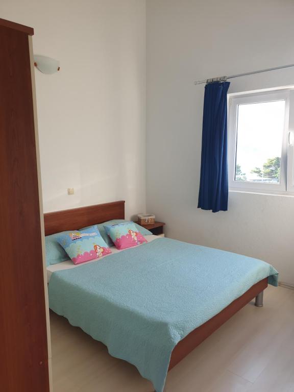 Posteľ alebo postele v izbe v ubytovaní Apartmani Mlikotić