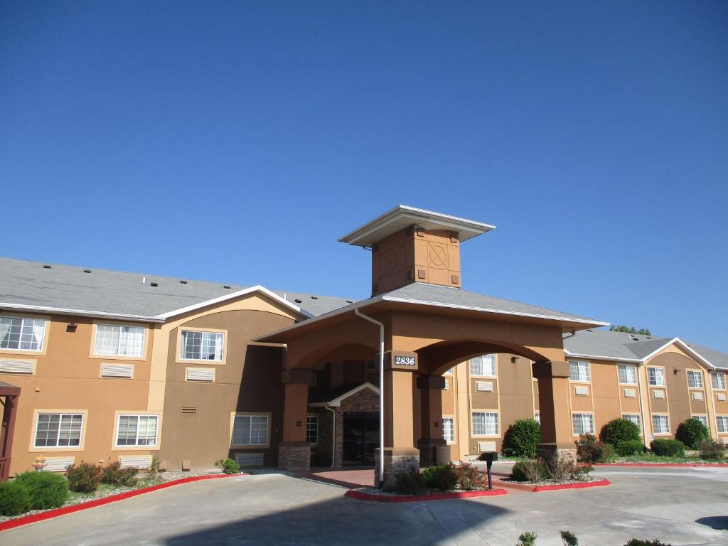 a large building with a clock tower in a parking lot at Best Western Emporia Inn in Emporia