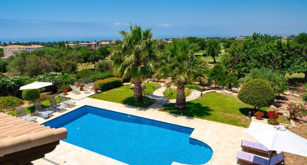 an aerial view of a swimming pool in a resort at 4 bedroom Villa Lofou with private pool and sea views, Aphrodite Hills Resort in Kouklia