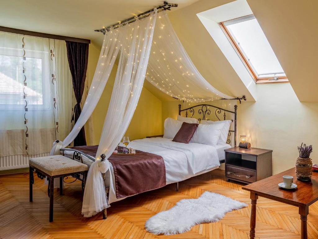 a bedroom with a bed with a canopy at Lavanda Apartment in Sighişoara