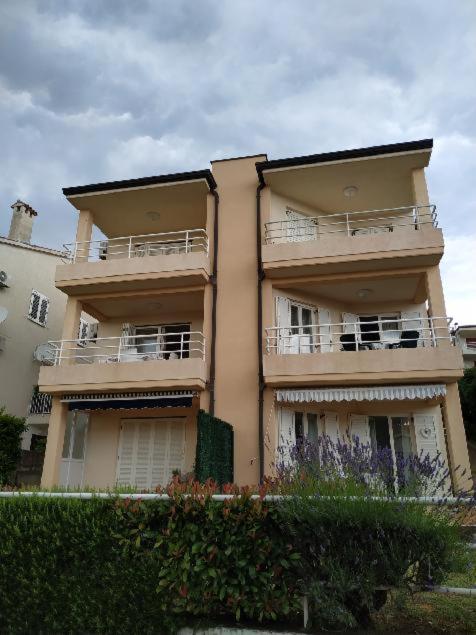a tall building with balconies on the side of it at APARTMANI INES RABAC in Rabac