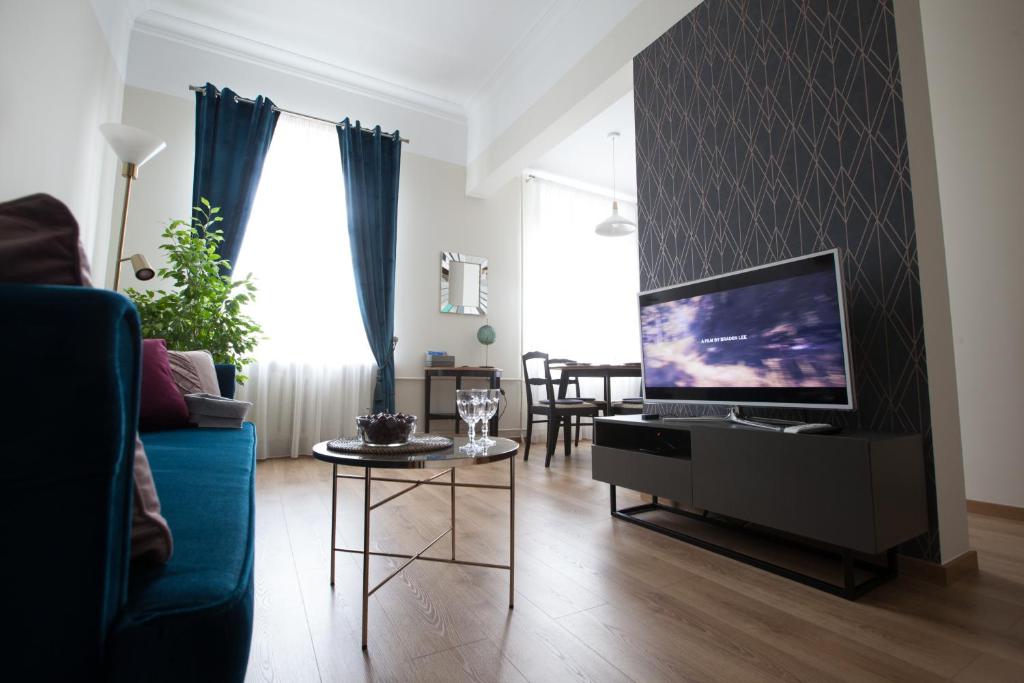a living room with a tv and a couch at Cozy Home Valdemara, free parking, self check-in in Riga