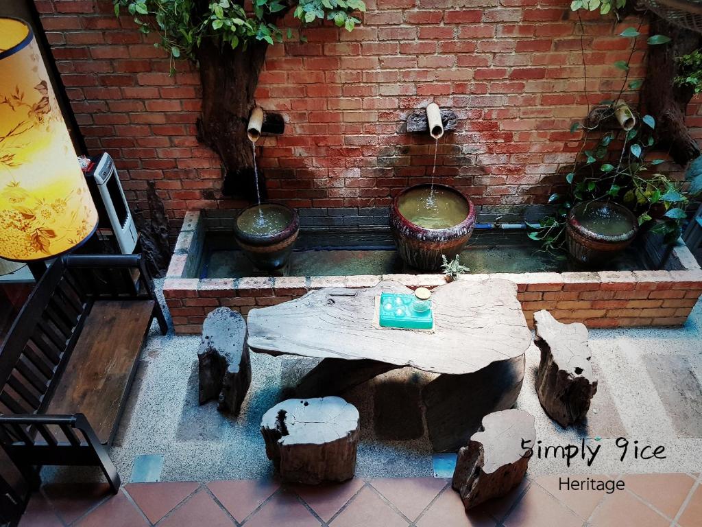 a table in a brick wall with some plants at 5imply 9ice Heritage in George Town