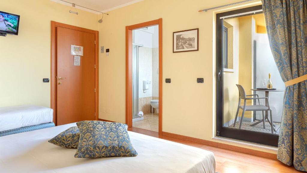 Postel nebo postele na pokoji v ubytování Hotel Postumia