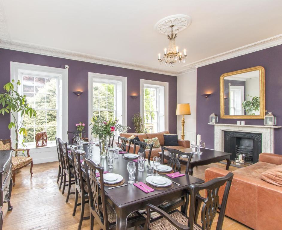 a living room with a table and chairs and a couch at Georgian Townhouse in Bristol