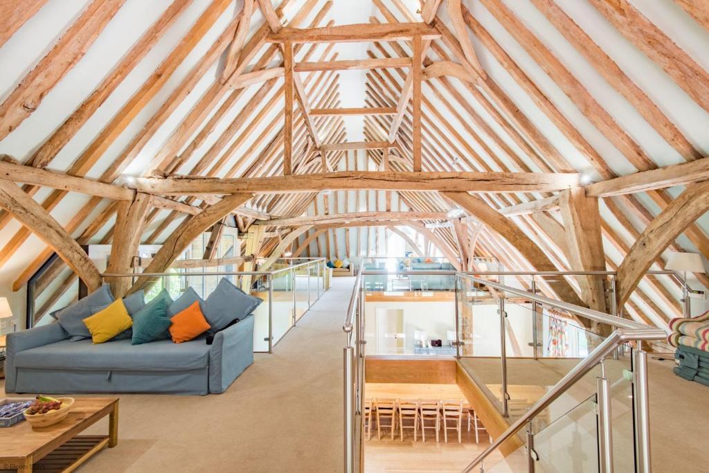 a living room with a blue couch in a barn at Great Higham Barn by Bloom Stays in Canterbury