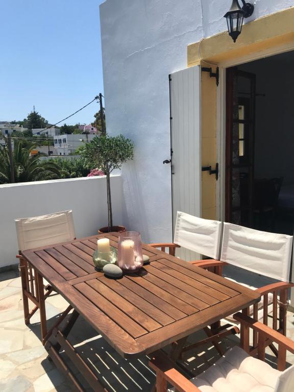 a wooden table with candles on a patio at Livadi center mountain view apartment in Livadi