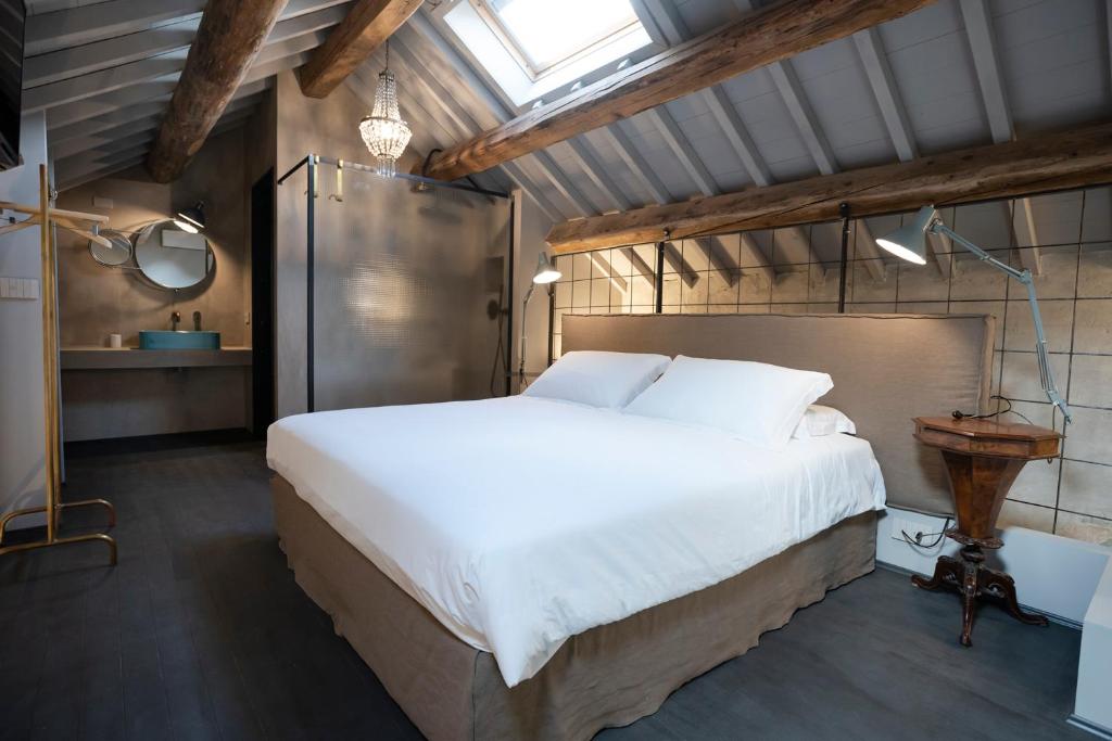 ein Schlafzimmer mit einem großen weißen Bett und einem Fenster in der Unterkunft CasaZavi in Belluno
