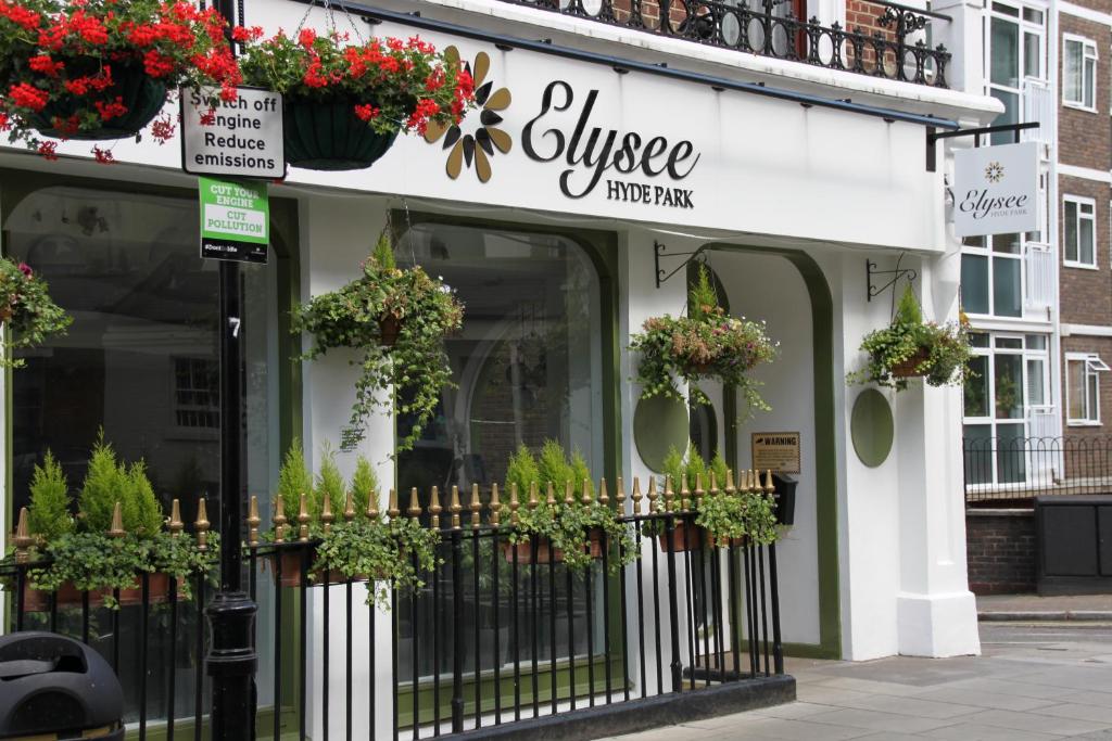 a store with potted plants on the front of a building at Elysee Hyde Park in London