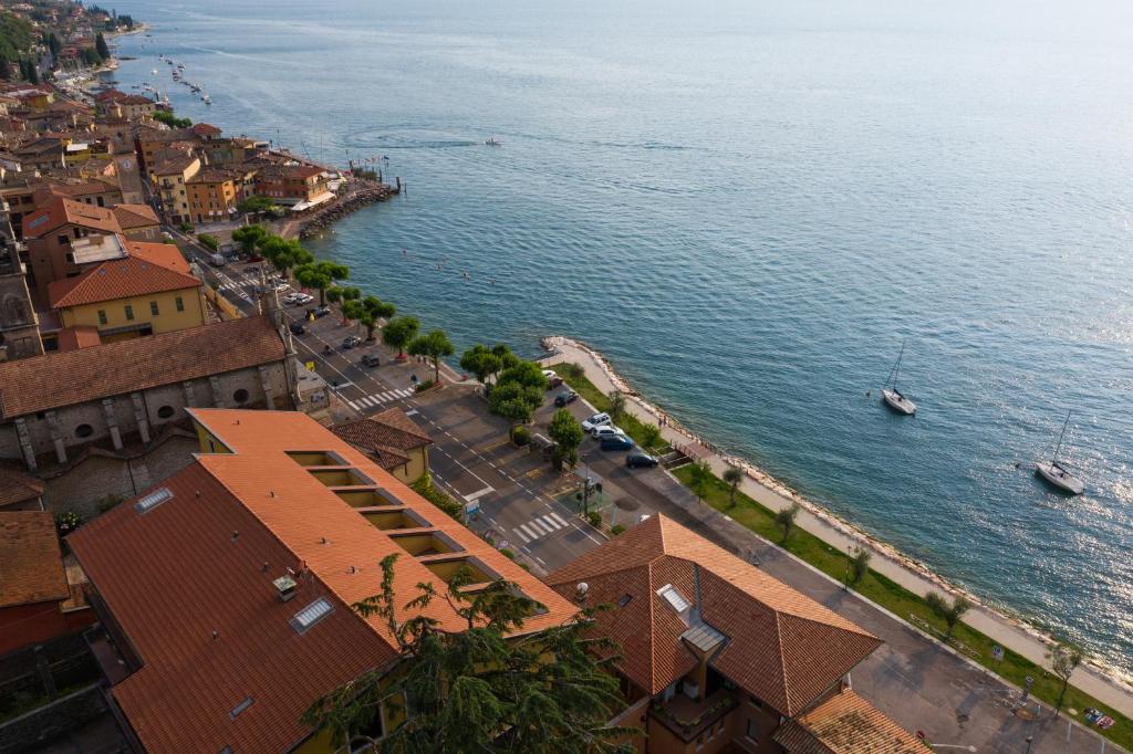 an aerial view of a town next to the water at Garda Family House in Brenzone sul Garda