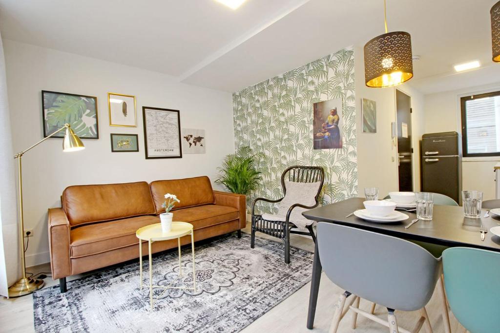 a living room with a couch and a table at Leidse Square City Centre Private Apartments in Amsterdam