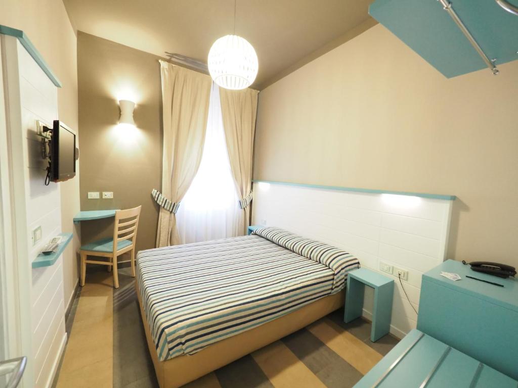 Una cama o camas en una habitación de Hotel La Spiaggia