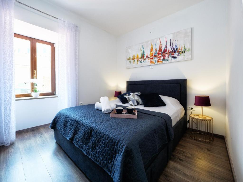 Łóżko lub łóżka w pokoju w obiekcie Arena Delight Studio Apartments