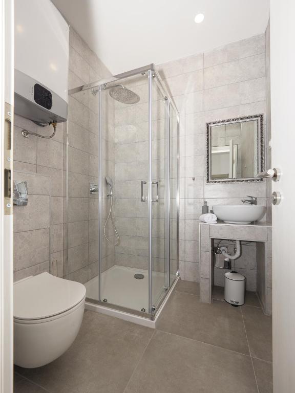łazienka z prysznicem, toaletą i umywalką w obiekcie Arena Delight Studio Apartments w Puli
