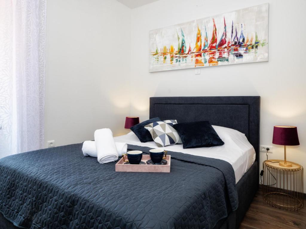 Łóżko lub łóżka w pokoju w obiekcie Arena Delight Studio Apartments