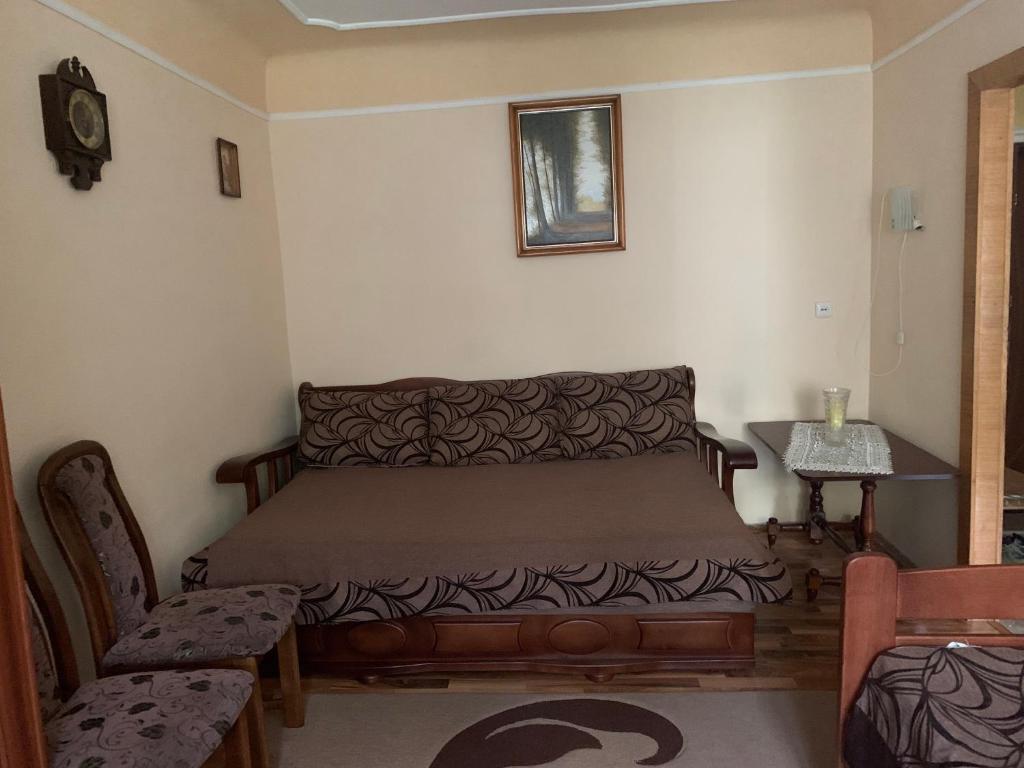 a bedroom with a bed and a table and a chair at Квартира Моршин in Morshin
