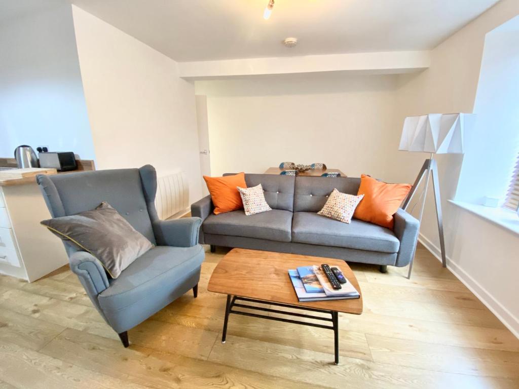 a living room with a couch and a coffee table at Nordic Suites Apartment, Ulverston in Ulverston