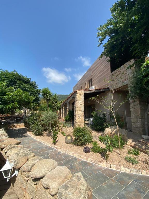a stone house with a stone walkway at Hotel gite d'etape San Pasquale in Conca