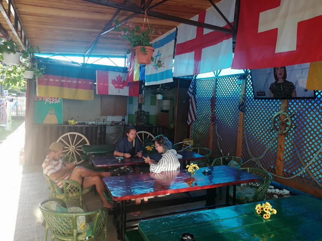 a group of people sitting at a table in a restaurant at Vila Flory & Crystiana in Costinesti
