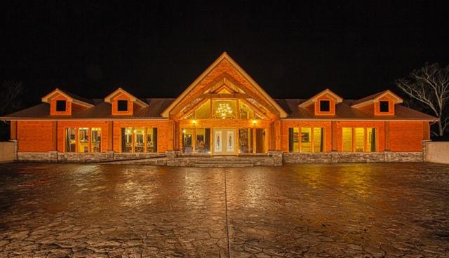 a large house is lit up at night at Gatlinburg Mansion Cabin in Pittman Center