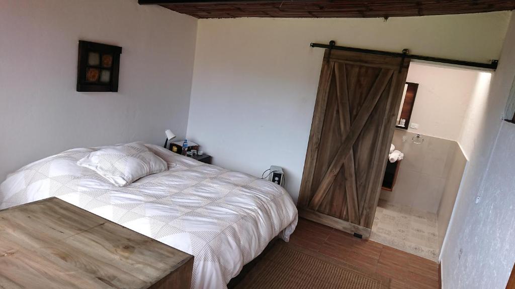 Postel nebo postele na pokoji v ubytování Hacienda El Rejo
