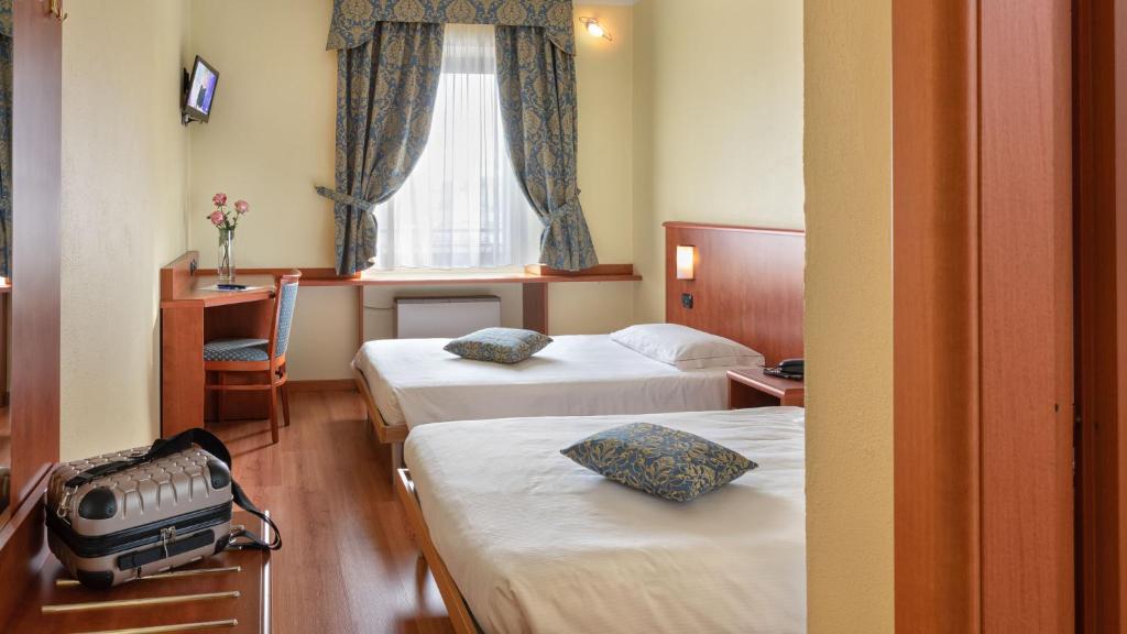 Postel nebo postele na pokoji v ubytování Hotel Postumia