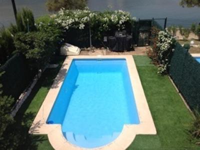a large blue swimming pool in a yard at Chalet Llac in Port d'Alcudia