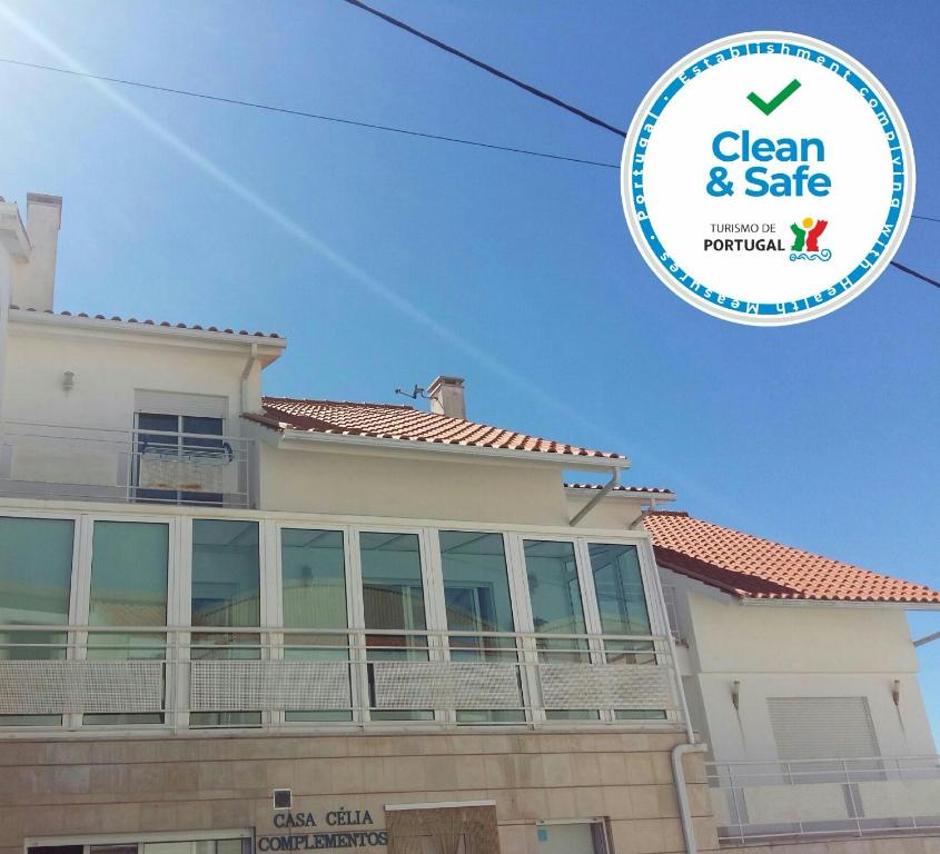 a house with a sign that says clean and safe at Casa Celia in Nazaré
