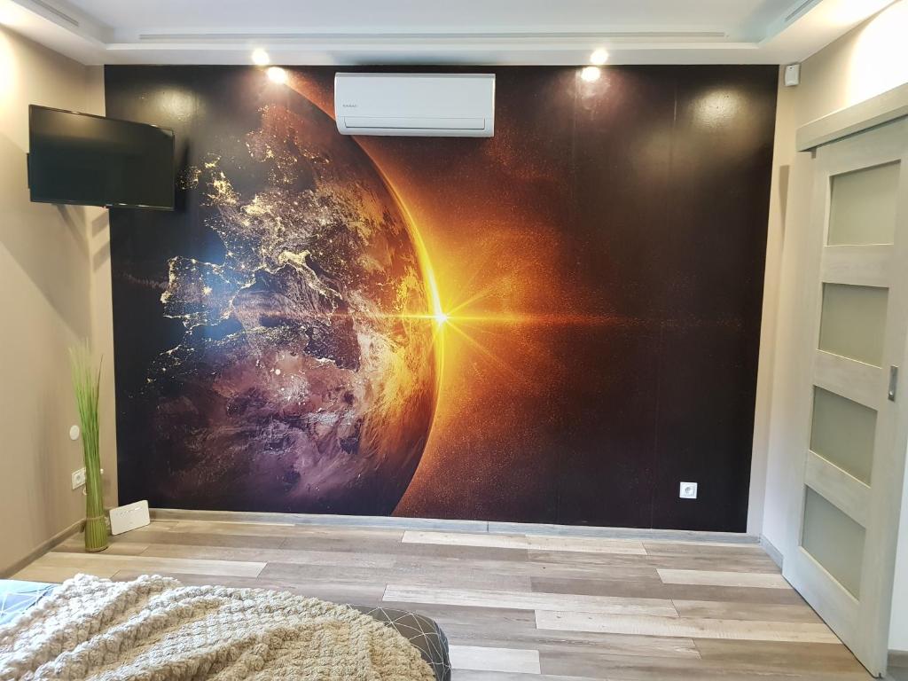 an empty room with an outer space mural on the wall at zacisze in Jelenia Góra