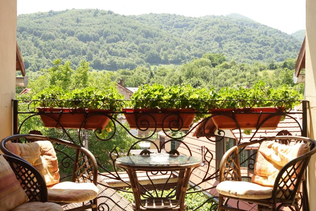 a balcony with a table and chairs with a view at Casa Ciortea Ana in Sibiel