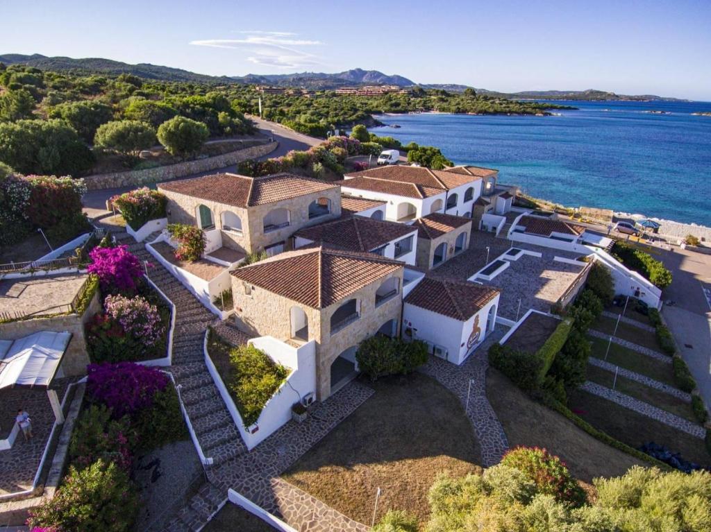 an aerial view of a villa with the ocean at Le Sirene in Marina di Portisco