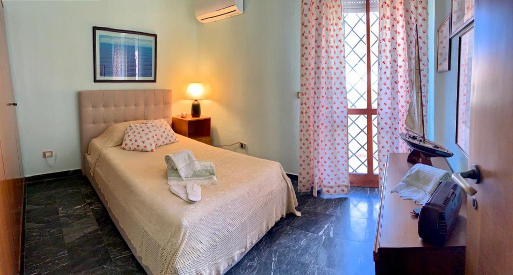 a bedroom with a bed with two pillows on it at Villa il Vento e il Mare in Selargius