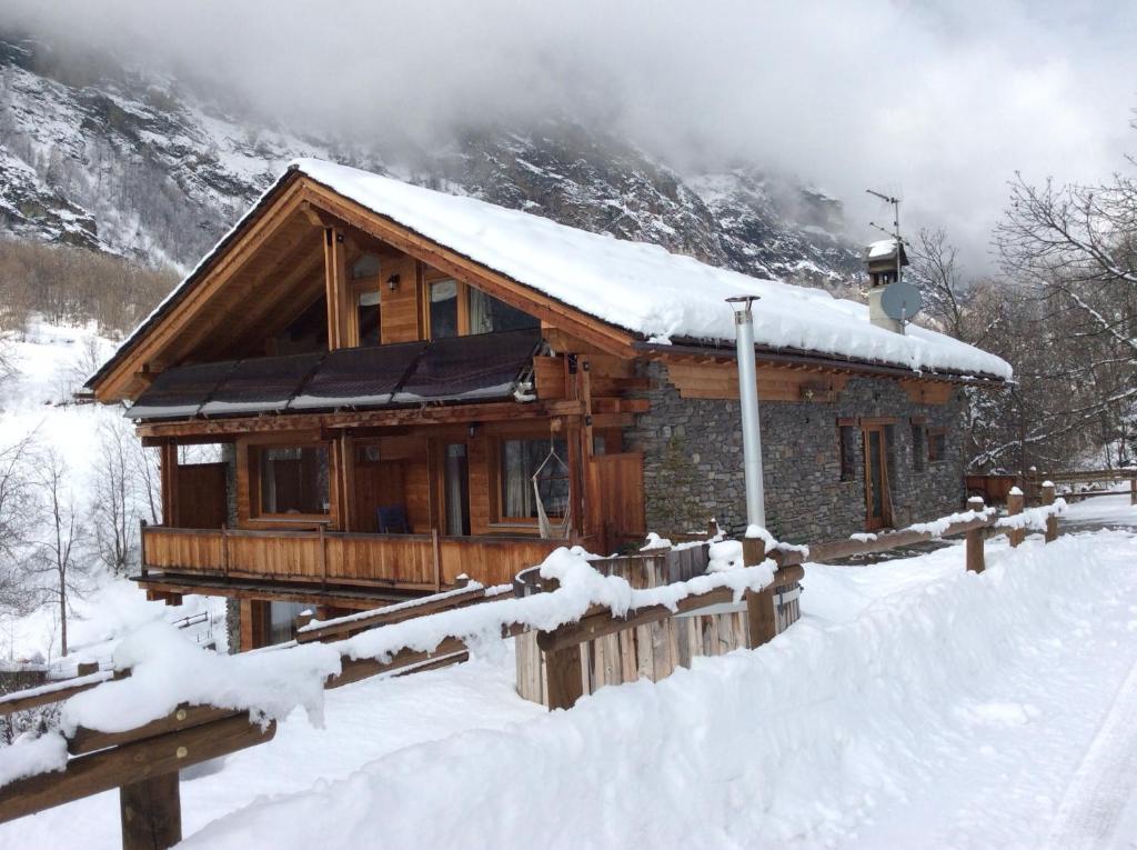 a log cabin in the snow with snow at La Maison du Guide in Rhemes-Saint-Georges