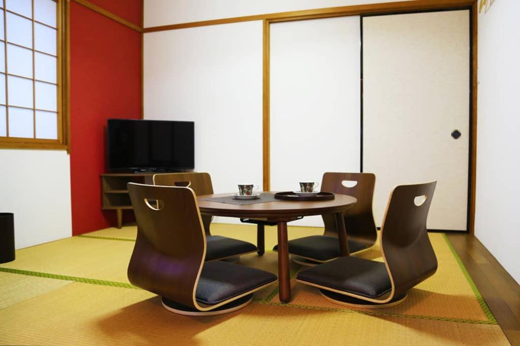 a dining room with a table and chairs at Tsukuyomi Chuodori in Kanazawa