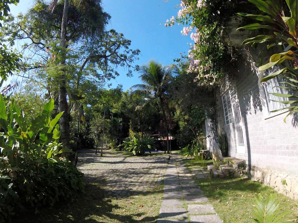 einen Garten mit Palmen und ein Gebäude in der Unterkunft Rio Natureza apart 112 in Rio de Janeiro