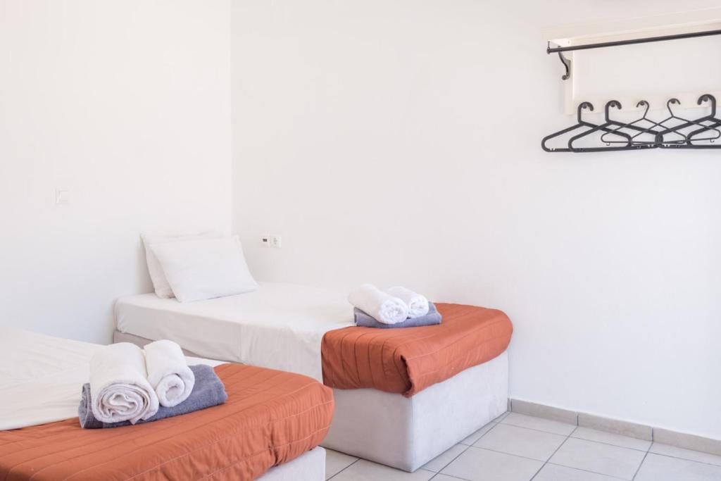 Łóżko lub łóżka w pokoju w obiekcie Paradise Apartments Studios