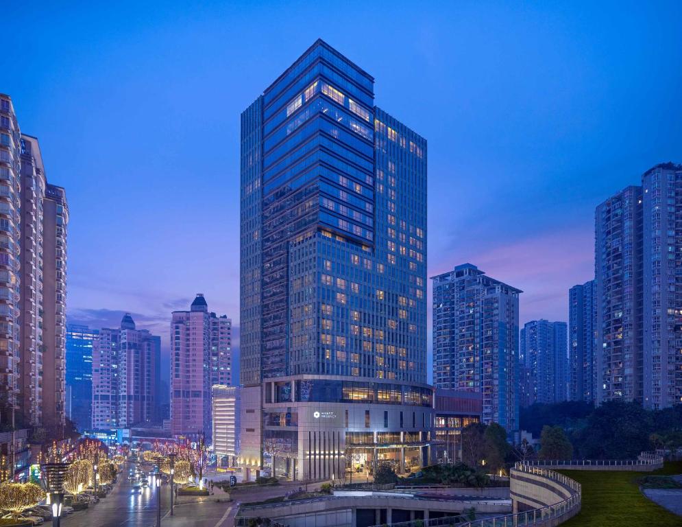 a tall building in a city at night at Hyatt Regency Chongqing Hotel in Chongqing